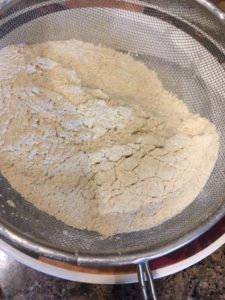Sifting dry ingredients namely wheat flour, baking powder, baking soda and salt