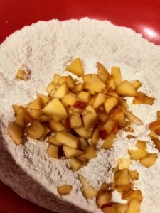 Dust chopped peaches with flour