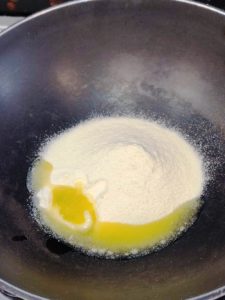 Take milk powder and ghee in a pan