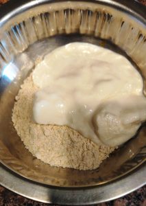 Take Jowar flour and curd in a bowl