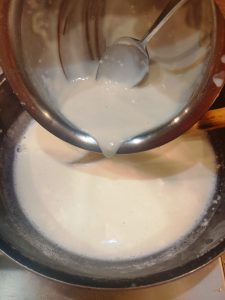 Add corn flour slurry to warm milk