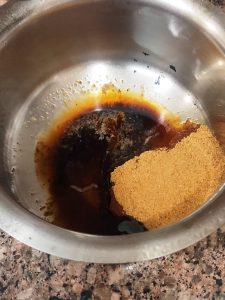 Take sifted jaggery powder, coffee powder and warm water in a big bowl
